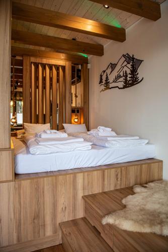 a large white bed in a room with at Panoráma Cottage in Nyúl