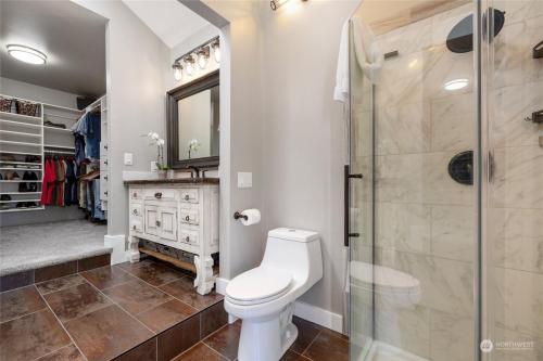 a bathroom with a toilet and a shower at Luxe At Louise in Tacoma