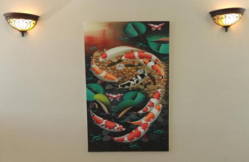a painting of a snake hanging on a wall at Luxe At Louise in Tacoma