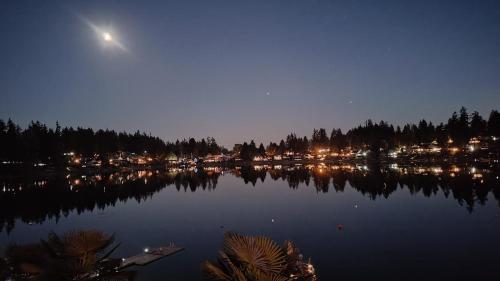 a view of a lake at night with the moon at Luxe At Louise in Tacoma
