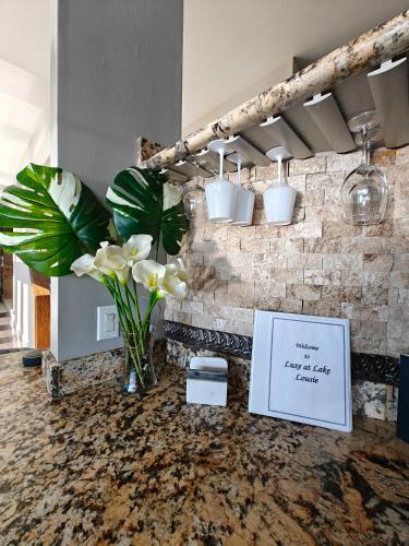 a table with a vase of flowers on a counter at Luxe At Louise in Tacoma