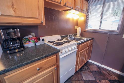 a kitchen with a white stove and a sink at Fawn Valley Inn- Cabana apts in Estes Park