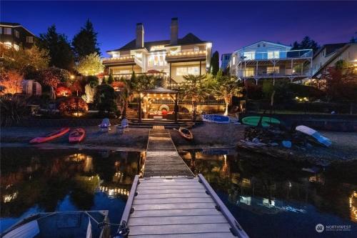 a house with a dock in front of the water at Luxe At Louise in Tacoma