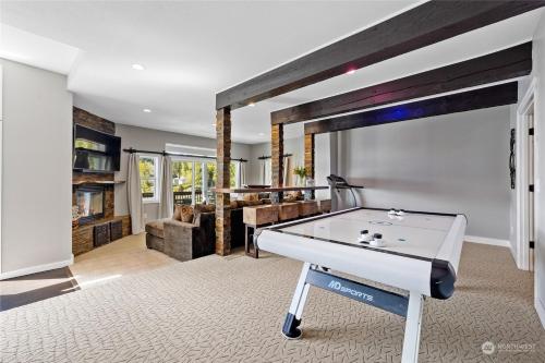 a living room with a ping pong table at Luxe At Louise in Tacoma