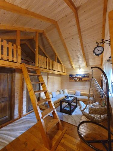 a room with a loft bed and a couch at Cabin House Dubovik in Cetinje