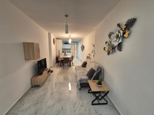 a living room with a couch and a table at 3BR Family Stay Near Valletta in Hamrun