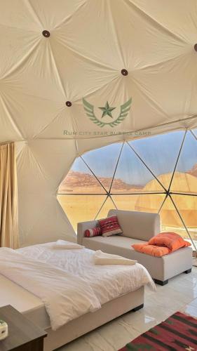a bedroom with a bed in a tent at RUM CITY STAR BUBBLE lUXURY CAMP in Wadi Rum