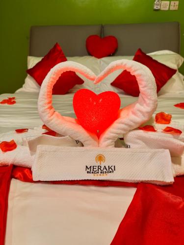 two hearts are made out of towels on a bed at MERAKI BEACH RESORT Lodges in Lomé