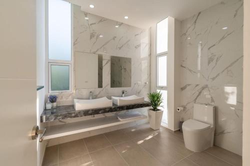 a bathroom with two sinks and a large mirror at Villa Pasha , dream villa in Xpuha , Riviera Maya in Xpu Ha