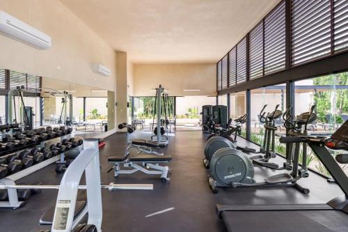 a gym with a lot of treadmills and machines at Villa Pasha , dream villa in Xpuha , Riviera Maya in Xpu Ha