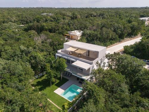 an aerial view of a house with a swimming pool at Villa Pasha , dream villa in Xpuha , Riviera Maya in Xpu Ha