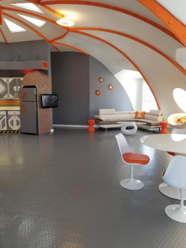 a living room with an orange and white ceiling at The Spaceship House! in Navarre