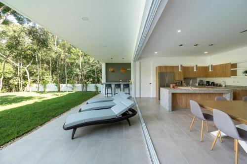 a kitchen and dining room with a table and chairs at Villa Pasha , dream villa in Xpuha , Riviera Maya in Xpu Ha