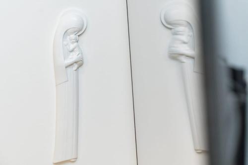 a pair of white handles on a door at Bogdanović Winery Apartman in Ilok