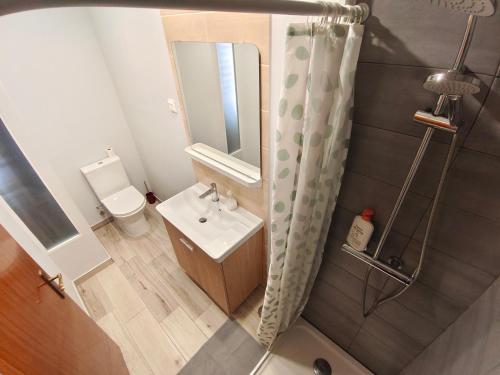 a small bathroom with a sink and a toilet at Residencial Marialva Park in Corroios