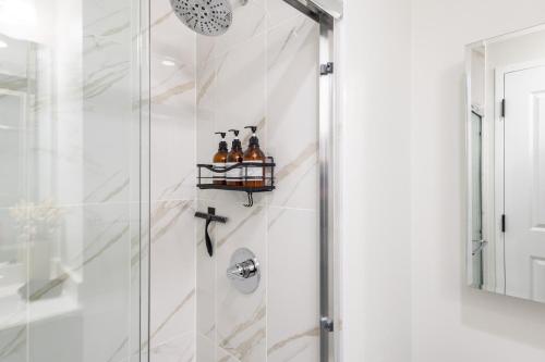 a shower stall with bottles of beer on a shelf at Chique Loft 15 Min from NYC with City View & Pool in Jersey City