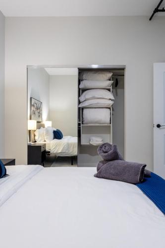 a stuffed teddy bear sitting on top of a bed at Chique Loft 15 Min from NYC with City View & Pool in Jersey City