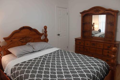a bedroom with a bed and a dresser and a mirror at Need to relax! Do it here! in Wave Crest
