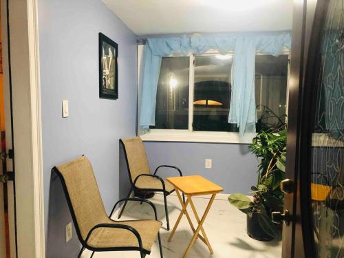 a room with two chairs and a table and a window at Need to relax! Do it here! in Wave Crest