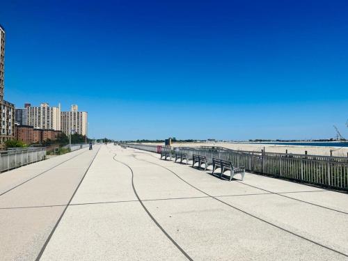 a boardwalk next to the beach with benches at Need to relax! Do it here! in Wave Crest