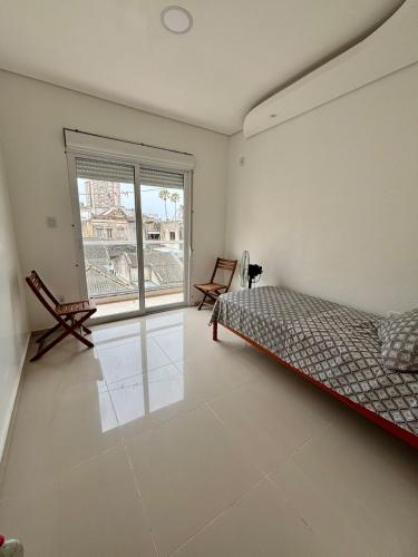 En eller flere senge i et værelse på Rio Grande Apartamento