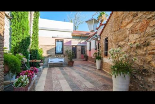 a courtyard of a house with flowers and plants at Home4U Κερατέα apt3, just 17Km from airport in Keratea