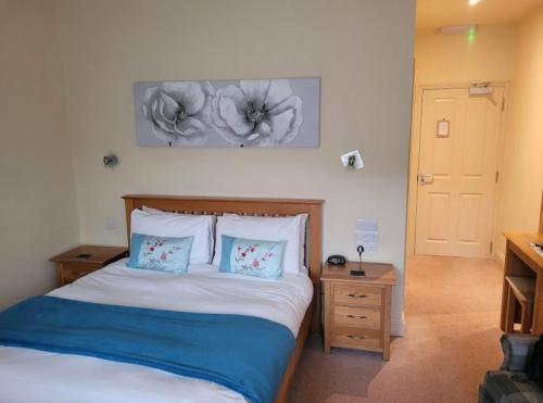 a bedroom with a bed with two pillows at Masons Arms in Montacute