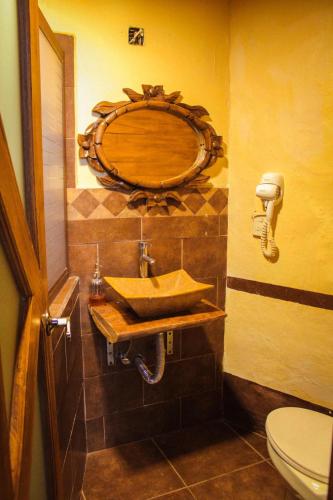 a bathroom with a sink and a toilet at Hotel y restaurante Cuenca Antigua in Mazamitla