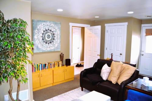 a living room with a couch and a book shelf at Cozy Nest Two Bedrooms in Grand Forks