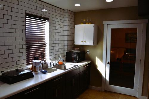 a kitchen with a sink and a microwave at Cozy Nest Two Bedrooms in Grand Forks