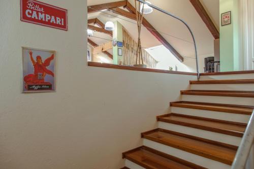 a staircase in a building with a sign on the wall at Villa Oleandri in Carmagnola