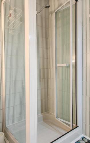 a shower with a glass door in a bathroom at Villa Oleandri in Carmagnola