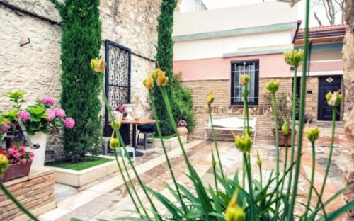 a garden with flowers in front of a building at Home4U Κερατέα apt4, just 17km from airport in Keratea