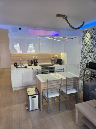 a kitchen with a table and two chairs and a counter at Luxury Alondras E108 in Arona