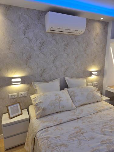a bedroom with a large bed with a wall at Luxury Alondras E108 in Arona
