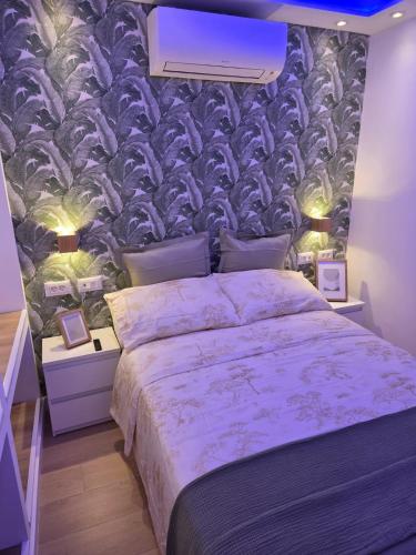 a bedroom with a bed with a purple wall at Luxury Alondras E108 in Arona
