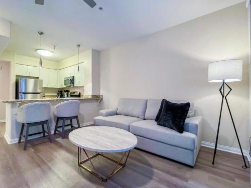 a living room with a couch and a table and a kitchen at Cozy Studio near Los Angeles Museum of Art in Los Angeles