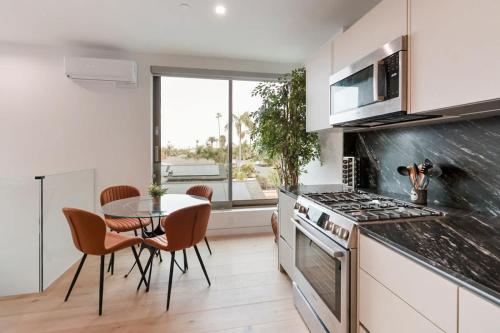 a kitchen with a table and a stove top oven at Ocean View Luxury Living in Carlsbad