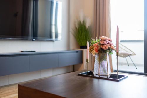 a vase of flowers sitting on top of a table at Cozy Coastal Bliss 1 in Ulcinj
