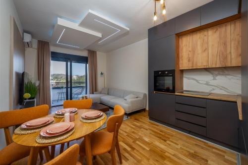 a kitchen and living room with a table and chairs at Cozy Coastal Bliss 1 in Ulcinj
