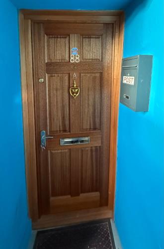 a wooden door with a sign on it at City Centre Modern 2 bedroom apartment in Perth
