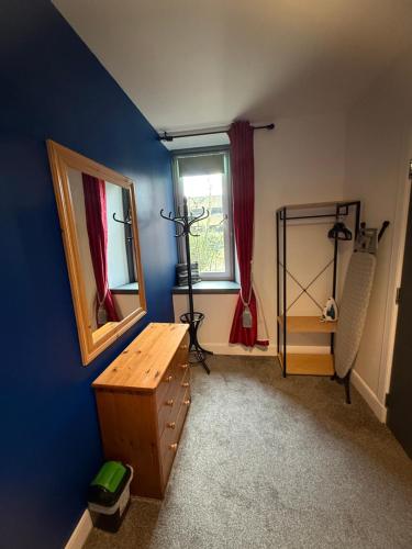 a room with a mirror and a dresser and a window at City Centre Modern 2 bedroom apartment in Perth