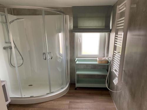 a bathroom with a shower with a glass shower stall at Chalet Dune near Dutch Coastline in Koudekerke