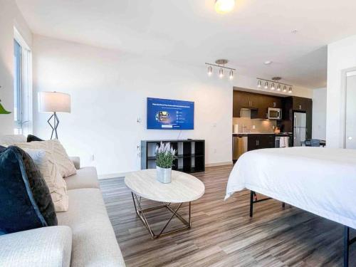 a living room with a bed and a couch and a table at Studio Downtown Walk to Convention Center in Los Angeles