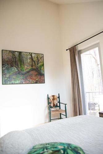a dog sitting in a chair in a bedroom at Ferienwohnung mit Stil in Georgenthal