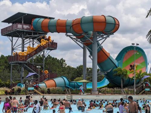 a crowd of people in a pool at a water park at Sunny Stay Orlando Queen Room 5 with Shared Bath in Orlando