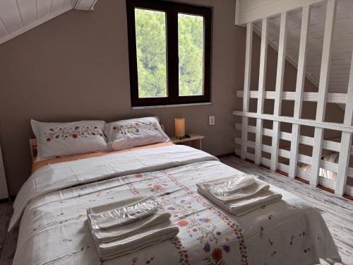 a bedroom with a bed with towels on it at Keyfe Kadir Garden Butik Otel in Orhangazi