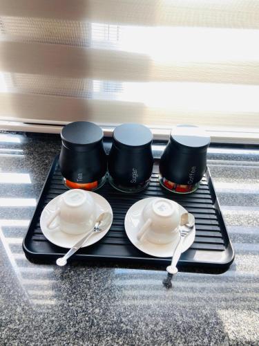 a tray with plates and utensils on a stove at The Orange Corner in Johannesburg