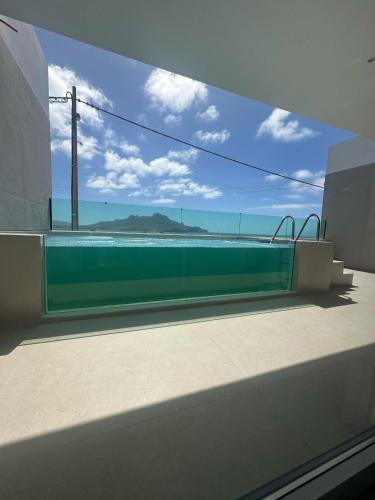 a view of the ocean from a balcony of a building at Sal Apartment in Mindelo