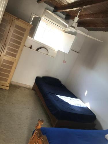 a bedroom with a blue bed in a room at LUKA House in Dahab